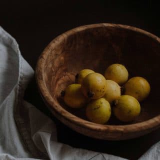 Wooden bowl full of biancolilla olives