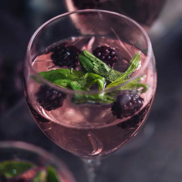 Blackberry ginger balsamic vinegar drink garnished with blackberries and mint