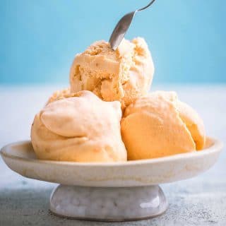 Cara cara orange ice cream scooped into a shallow bowl