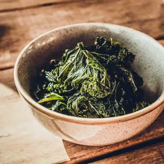 Bowl of kale leaves dressed in gremolata extra virgin olive oil