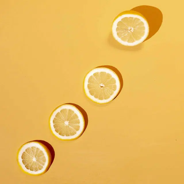 Sliced Italian lemons on a yellow background