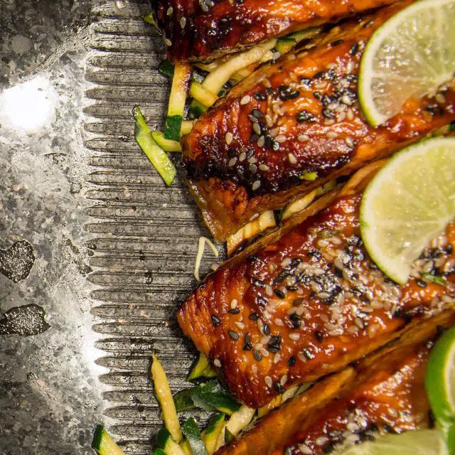 Salmon marinated in teriyaki balsamic vinegar and grilled, garnished with sliced lemons