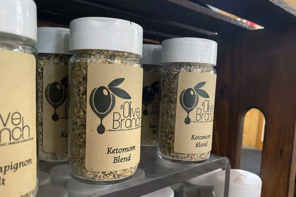 glass jars full of the Olive Branch's ketomom spice blend sitting on shelves